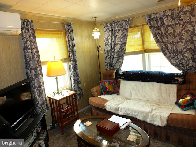 living room featuring a wall mounted air conditioner, carpet flooring, wood walls, and crown molding