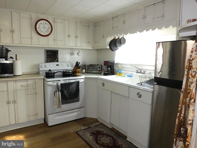 kitchen with white cabinetry, dark wood-type flooring, stainless steel appliances, and sink