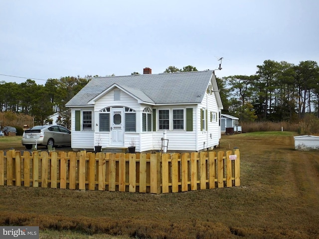 bungalow-style home featuring a front yard