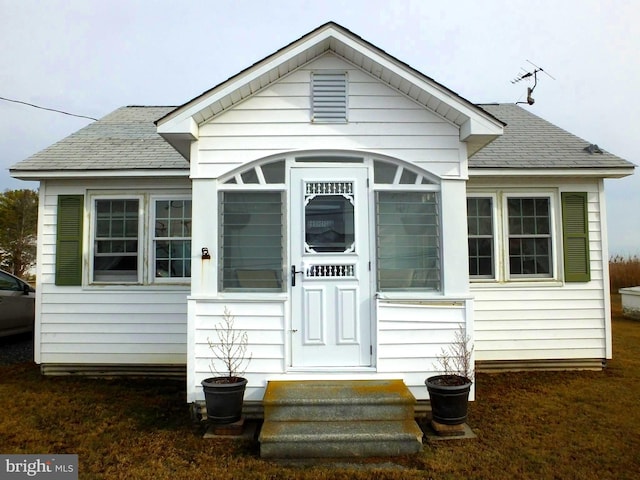 view of front of house with a sunroom