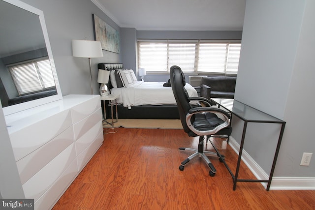 bedroom featuring hardwood / wood-style flooring and ornamental molding