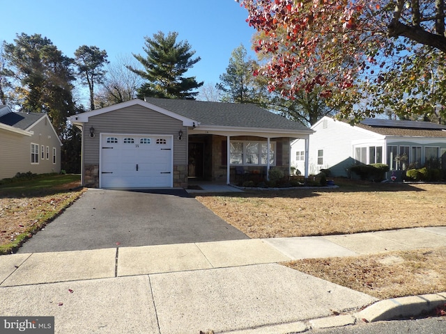 ranch-style home with a garage and a front yard