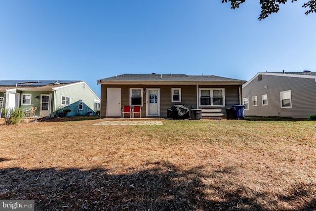 back of property featuring central air condition unit and a yard