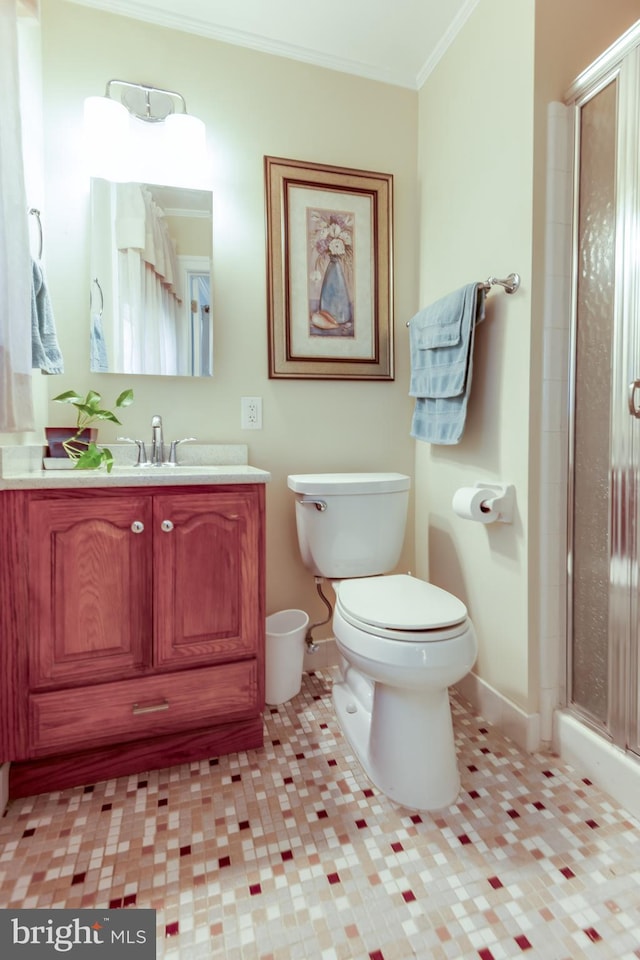 bathroom featuring toilet, vanity, a shower with door, and ornamental molding