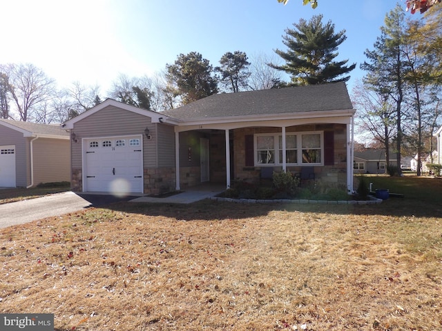 ranch-style house featuring a garage, a porch, and a front yard