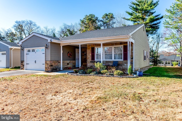 view of front of home with covered porch, a garage, and a front yard