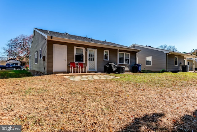 rear view of property featuring a yard