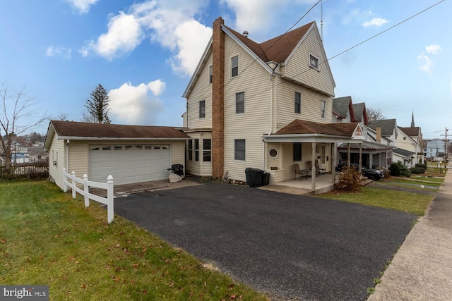 view of home's exterior with a lawn, a garage, and covered porch