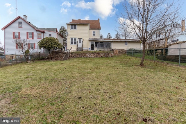 back of house with a lawn