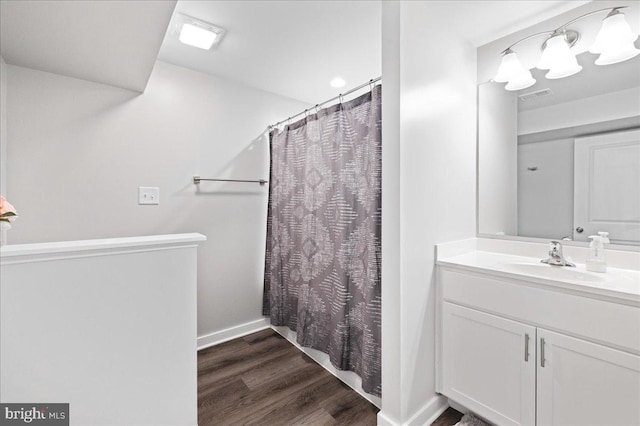 bathroom featuring vanity, wood-type flooring, and a shower with shower curtain