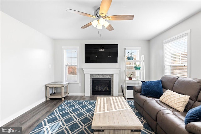 living room featuring ceiling fan, dark hardwood / wood-style flooring, and a wealth of natural light