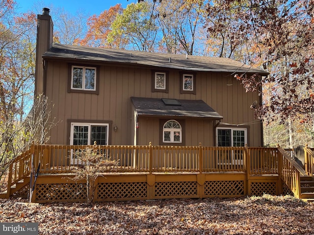 back of house with a wooden deck