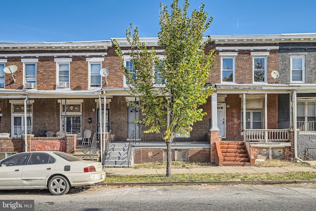 townhome / multi-family property featuring a porch