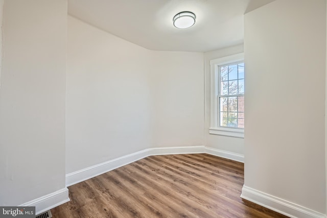 spare room featuring dark wood-type flooring