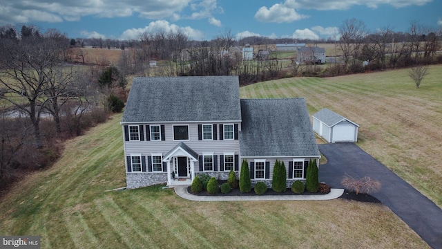 view of front of home with an outbuilding, a garage, and a front lawn