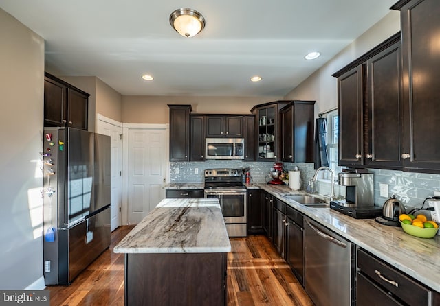 kitchen featuring tasteful backsplash, dark wood-type flooring, sink, and stainless steel appliances