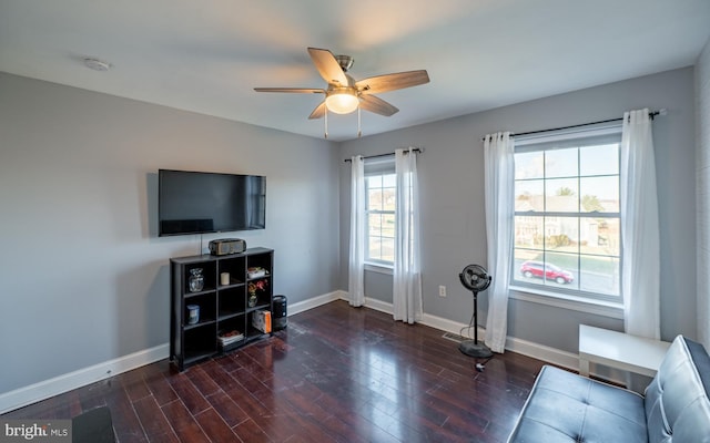 workout area with ceiling fan and dark wood-type flooring