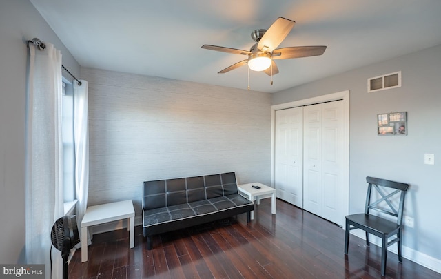 sitting room featuring ceiling fan and dark wood-type flooring