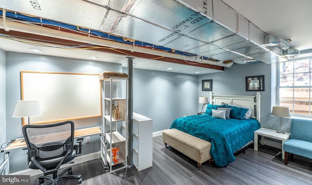 bedroom with dark wood-type flooring