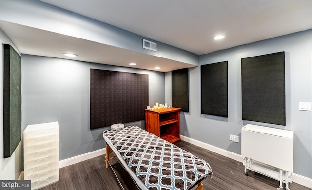 living area with dark hardwood / wood-style flooring and radiator