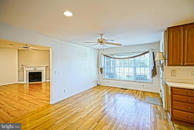 interior space with light hardwood / wood-style flooring and ceiling fan