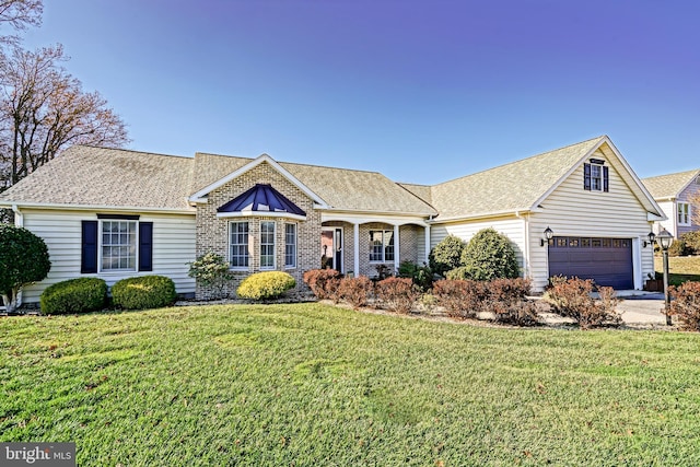 ranch-style house featuring a garage and a front lawn