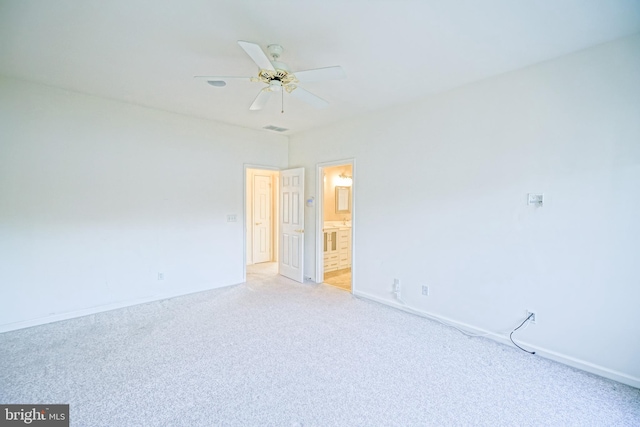 empty room featuring ceiling fan and light colored carpet