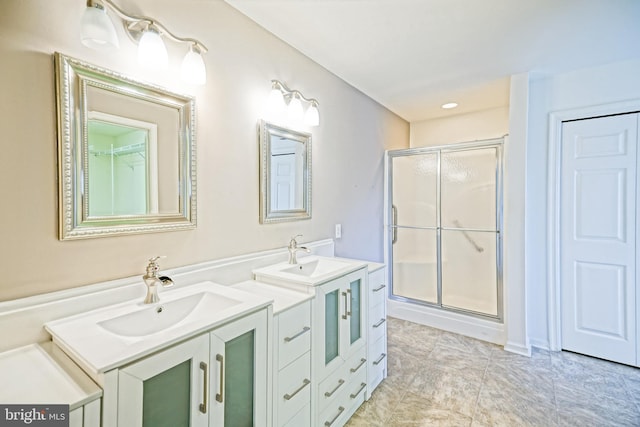 bathroom with vanity and a shower with shower door