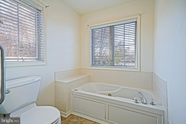 bathroom featuring a tub and toilet