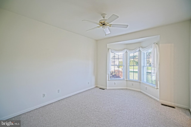 unfurnished room featuring light carpet and ceiling fan