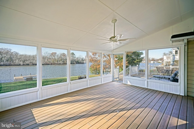 unfurnished sunroom featuring ceiling fan, a healthy amount of sunlight, a water view, and lofted ceiling