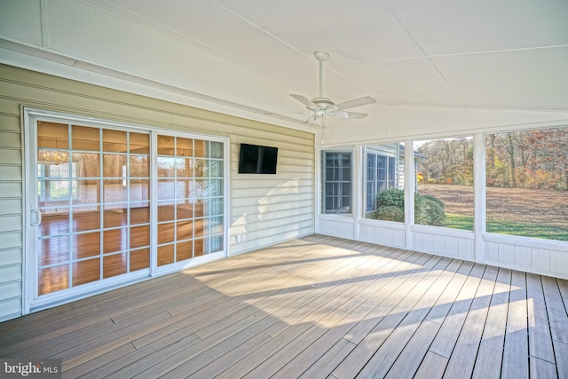 unfurnished sunroom with ceiling fan and vaulted ceiling