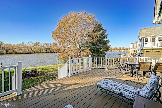 wooden terrace featuring a water view