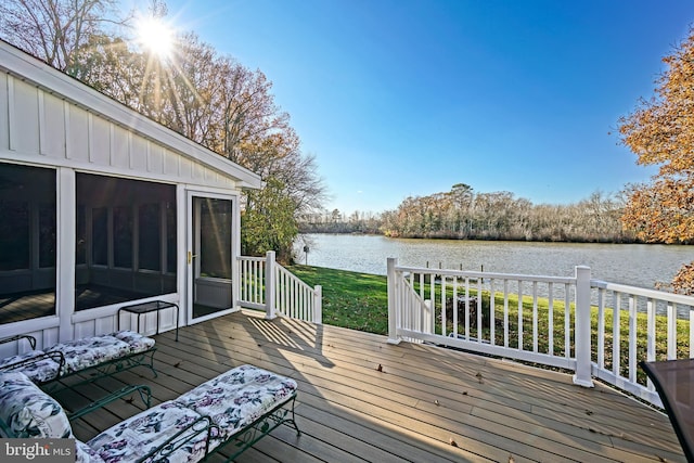 deck featuring a sunroom and a water view