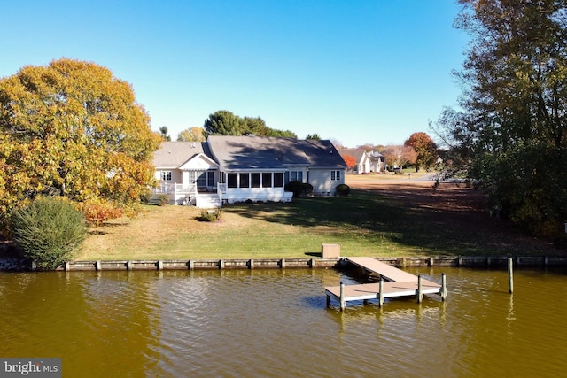 dock area with a water view and a yard