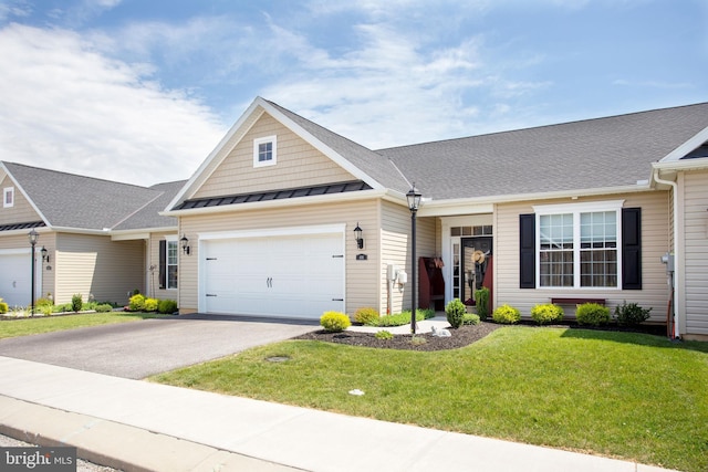 view of front of property featuring a front lawn and a garage