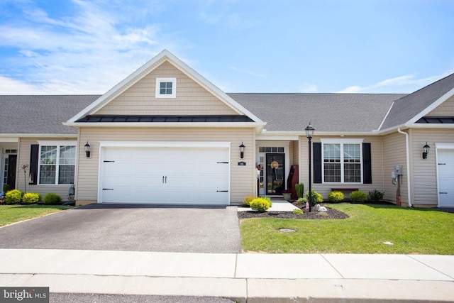 view of front facade with a garage and a front lawn