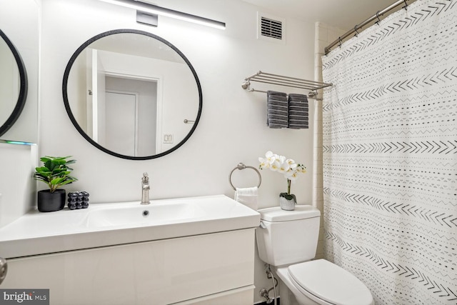 bathroom featuring vanity, toilet, and a shower with curtain