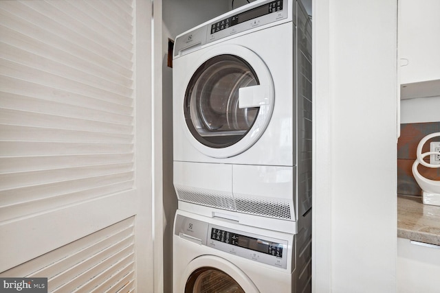 laundry area with stacked washer / drying machine