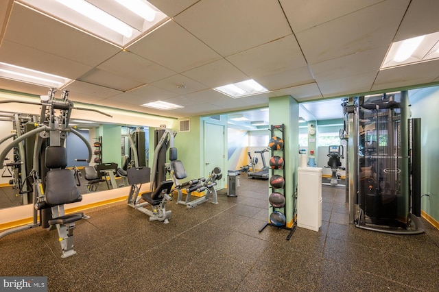 exercise room featuring a paneled ceiling