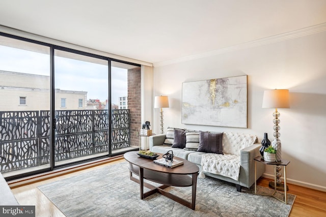 living room with floor to ceiling windows, hardwood / wood-style flooring, and crown molding