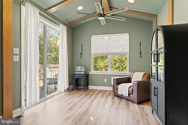 sitting room featuring light hardwood / wood-style floors, ceiling fan, and vaulted ceiling with beams