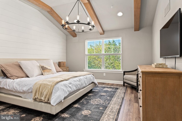 bedroom with hardwood / wood-style floors, a chandelier, and lofted ceiling with beams