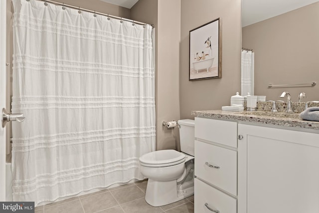 bathroom featuring toilet, vanity, and tile patterned floors