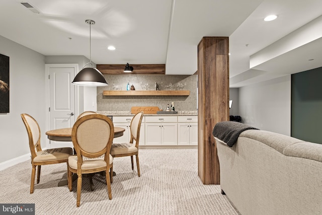 carpeted dining space with indoor bar