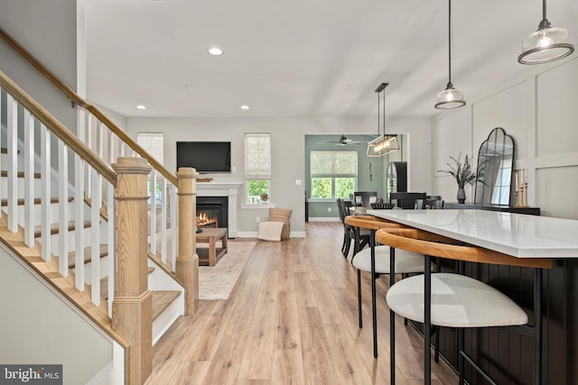 dining area featuring light wood-type flooring and ceiling fan