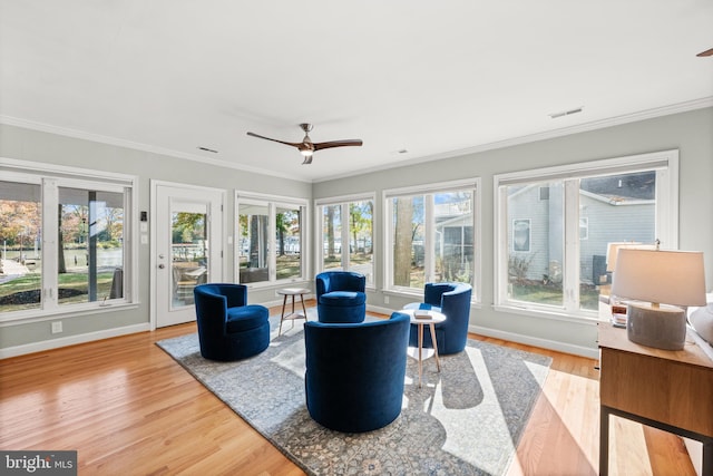 living room featuring hardwood / wood-style flooring, ceiling fan, and ornamental molding