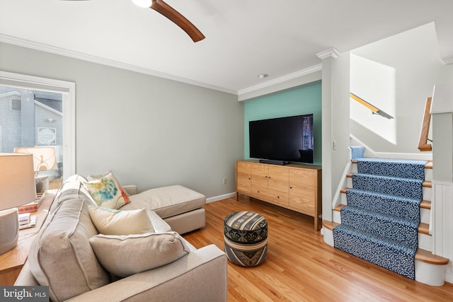 living room with hardwood / wood-style flooring, ceiling fan, and ornamental molding