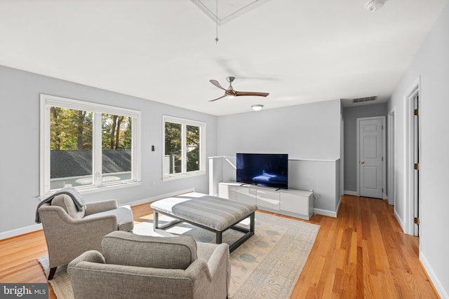 living room featuring ceiling fan and light hardwood / wood-style flooring