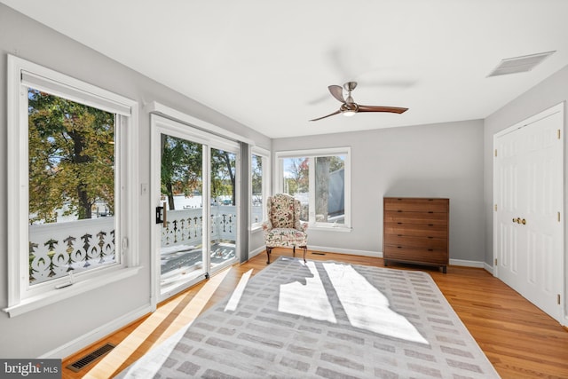 living area featuring ceiling fan and light wood-type flooring